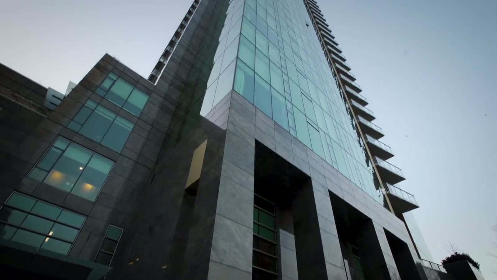 Modern glass office tower viewed from street level